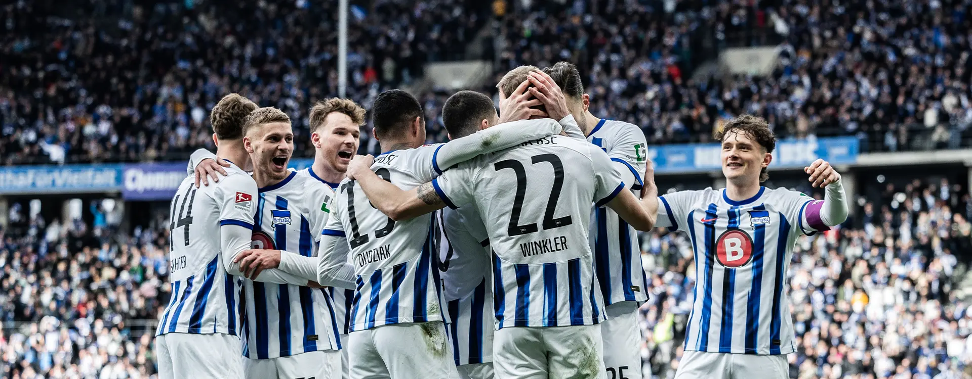 The image captures a moment of celebration for a soccer team. There are several individuals dressed in their sports attire, which matches with the branding associated with their team uniforms. They appear to be male players from a specific club, as indicated by the jerseys and badges on their outfits. The atmosphere suggests a positive outcome during the match they played, which is likely why they are smiling and congratulating each other.
The text overlaid on the image seems to be from an Instagram post featuring this scene. The context provided in English indicates that they have won their match and are celebrating their achievement. This is a common moment captured in sports photography when teams celebrate their victories after matches.