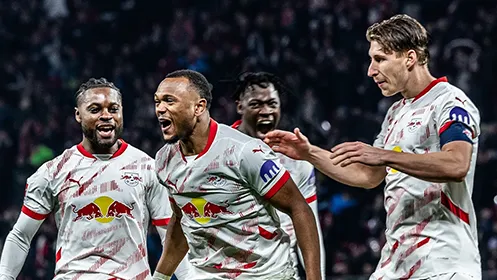 RB Leipzig players celebrate in white jerseys after scoring a goal. (Photo)